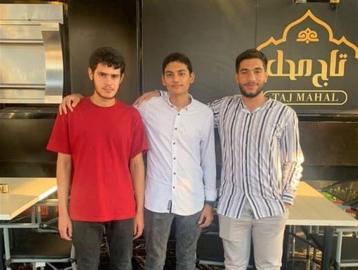 Yosef Beder standing with colleagues, Ismails