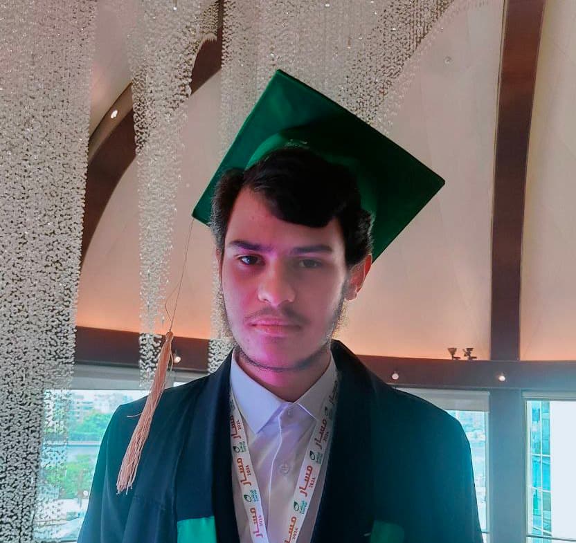 Yosef Beder wearing graduation gown at Egypt Post 1st celebration